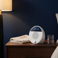 NightField Sound Machine on a bedside table in evening light